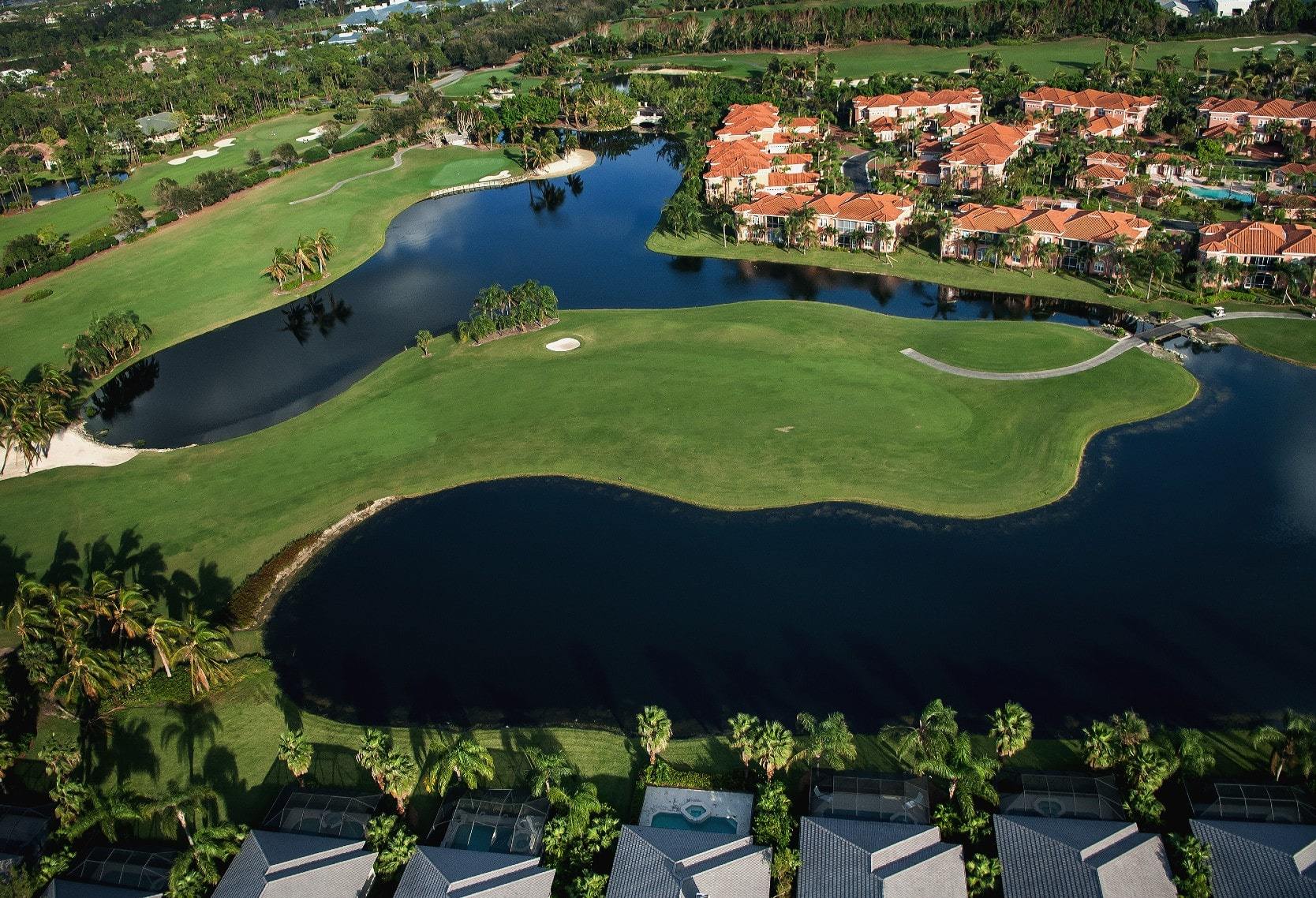 Aerial view of golf villas and vacation homes next to a golf course in Florida